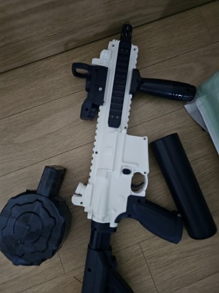 전동물총 M416의 충전 케이블과 물통 탄창 등의 구성품을 보여주는 사진